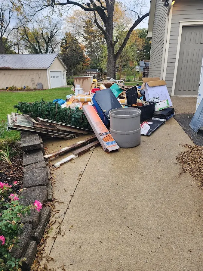 Dumpster being loaded with debris for 10 Yard Dumpster Rental in Boiling Spring Lakes